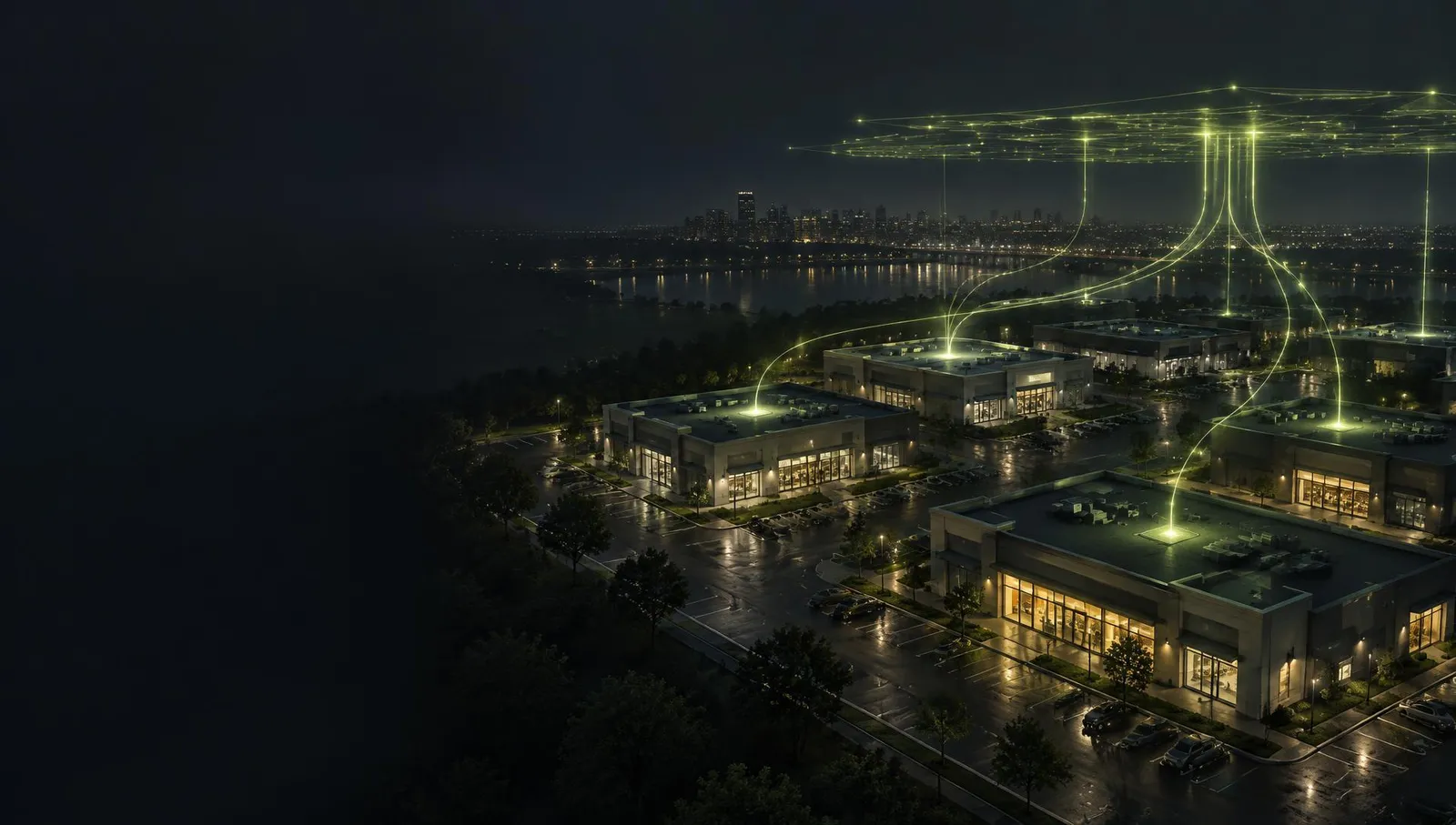 Concept illustration: electricity data from several commercial rooftops at night converging into a data layer above