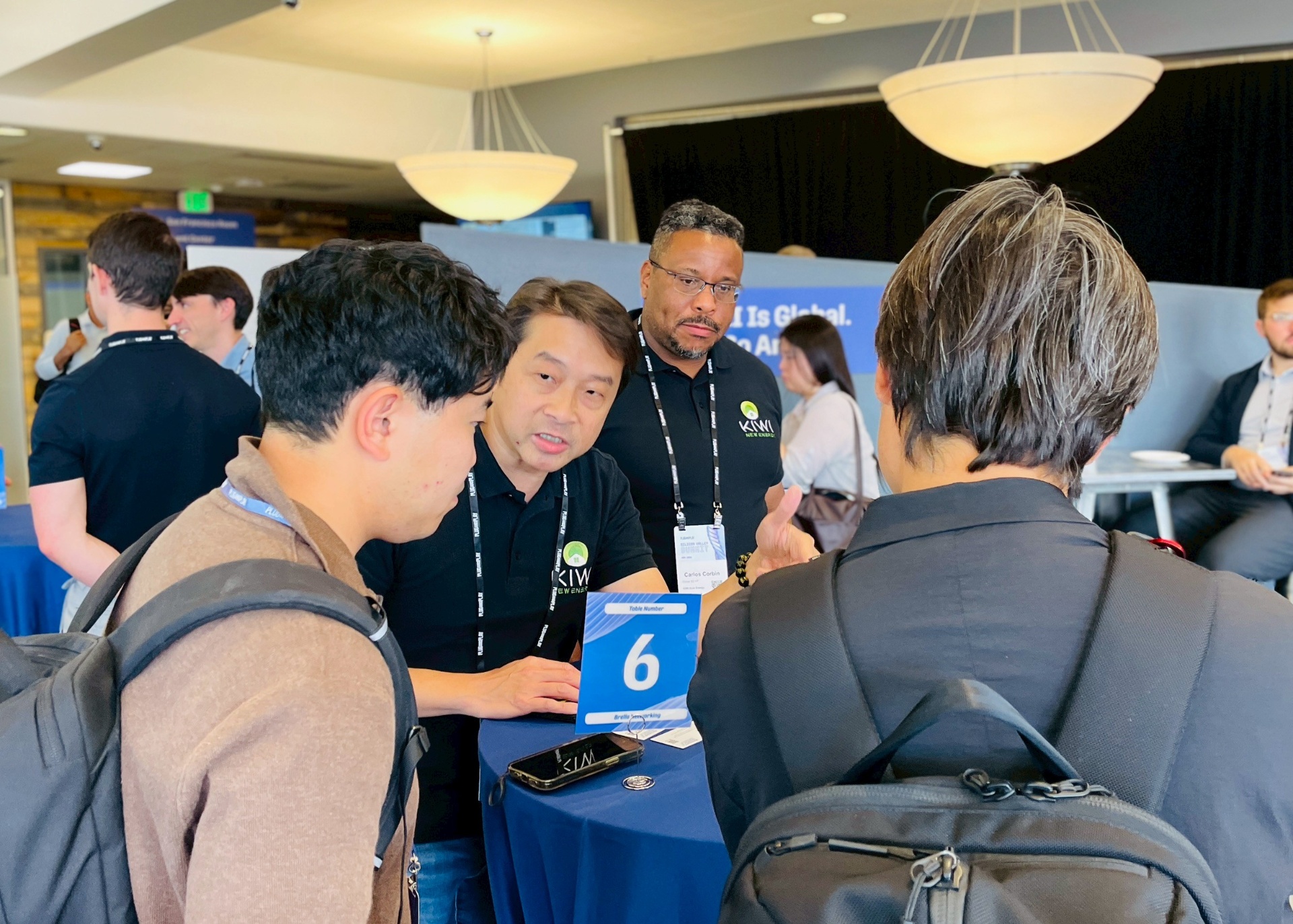1:1 partner meetings at Table 6 — KiWi's US team walking visitors through the AI Energy Operating System for retail, food service, and commercial portfolios.